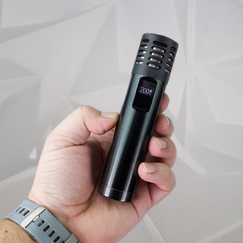Hand holding a Arizer Air Max vaporizer.