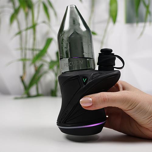 Focus V Carta Sport on a table while woman presses a power button