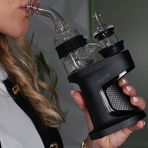 Woman inhaling from Ispire Daab Kit with the borosilicate glass mouthpiece
