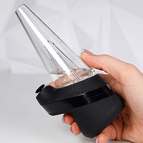 Woman holds Puffco Peak in her hands from the silicone base
