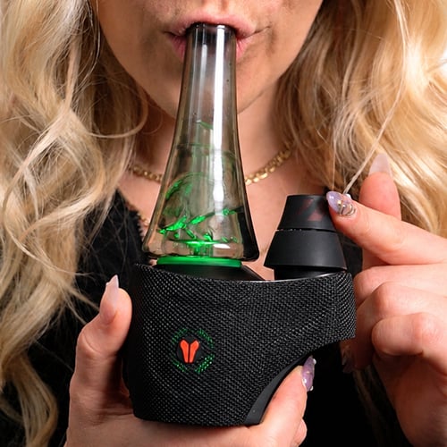 Woman inhaling from utillian 8 Turbo while spinning the dual spinner cap