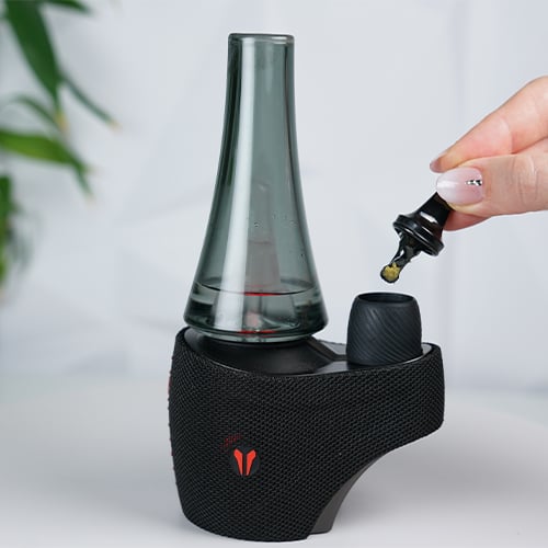 Utillian 8 v2 on a table while woman holds a multitool with wax