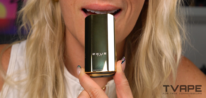 A woman is inhaling from the Zeus Arc GT4 vaporizer (Gold Edition)