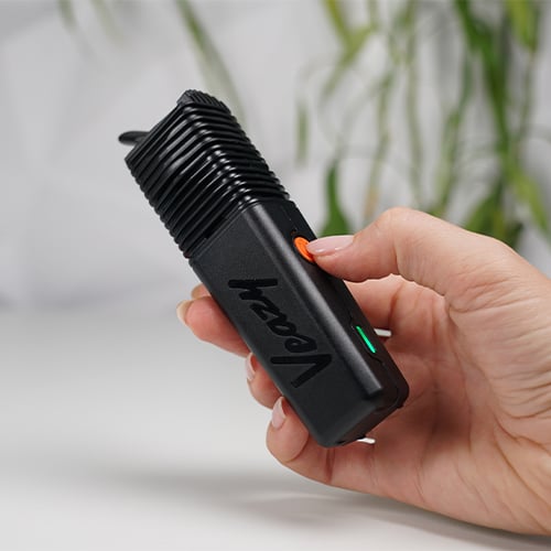 Hand holding a Veazy vaporizer.