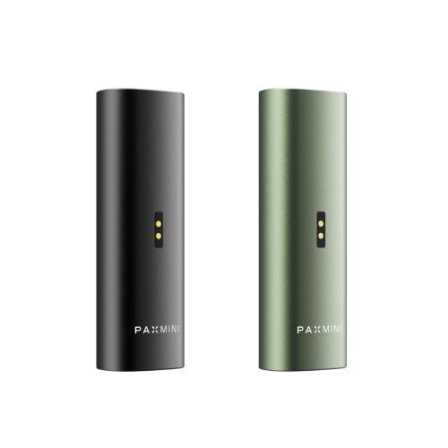 New PAX Mini vaporizers in Onyx and Greenstone colors, featuring charging ports at the back and the PAX Mini logo at the bottom of the sleek aluminum body.